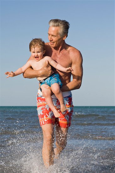 Grandfather and Grandson Running on Beach Stock Photo - Premium Rights-Managed, Artist: Kevin Dodge, Image code: 700-03484980