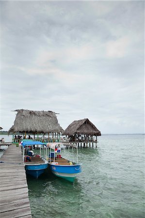 panama people - Boats and Thatched Roof Huts on Dock, Bastimentos Island, Bocas del Toro, Panama Stock Photo - Rights-Managed, Code: 700-03485149