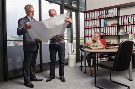 Architects in Office Looking at Model and Blueprints Fotografie stock - Rights-Managed, Codice: 700-03501268