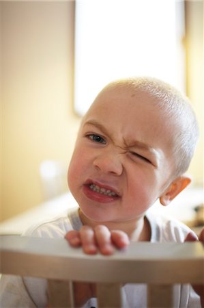 Toddler Winking over Back of Chair Stock Photo - Rights-Managed, Code: 700-03502754