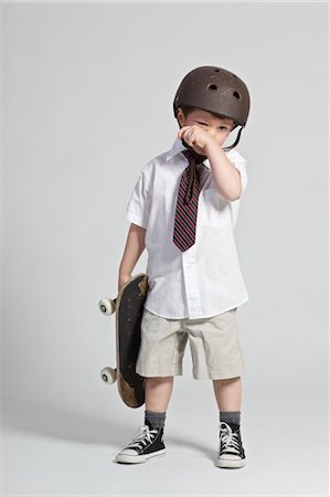 sad young boy - Boy in School Uniform Holding Skateboard and Wearing Helmet Stock Photo - Rights-Managed, Code: 700-03520396