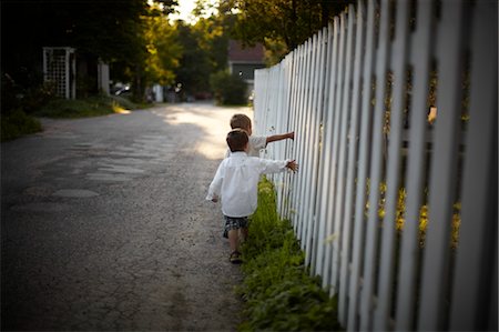 street neighbourhood north america - Boys Walking Beside White Picket Fence, Sauble Beach, Ontario, Canada Stock Photo - Rights-Managed, Code: 700-03520593