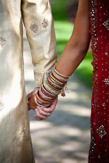 Close Up Of Bride And Groom Holding Hands Stock Photo