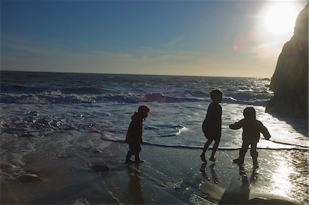 friends outdoors winter not woman - Three Children Playing on Shore, Quiberon, Gulf of Morbihan, France Stock Photo - Rights-Managed, Code: 700-03567980