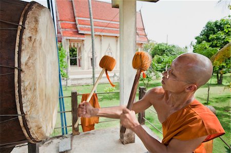 Buddhist Monk Drumming on Large Drum at Wat Dam Pia, Ubon Ratchatani, Thailand Stock Photo - Rights-Managed, Code: 700-03586725