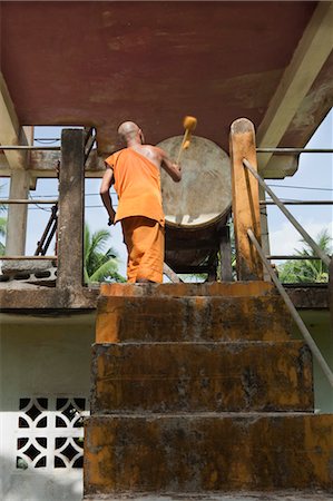 Buddhist Monk Drumming on Large Drum at Wat Dam Pia, Ubon Ratchatani, Thailand Stock Photo - Rights-Managed, Code: 700-03586722