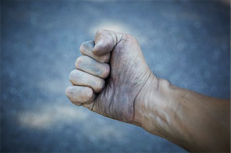 Man's Dirty Hand Clenched into Fist Stock Photo - Rights-Managed, Code: 700-03596227