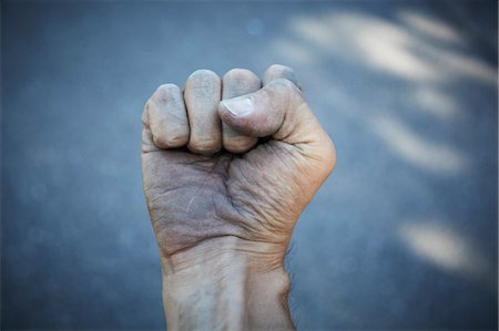 Man's Dirty Hand Clenched into Fist Stock Photo - Rights-Managed, Code: 700-03596228