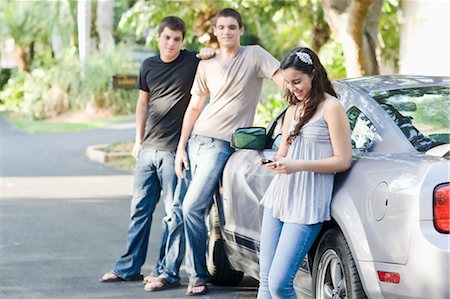 simsearch:649-06844580,k - Teenagers Leaning Against Car, Girl Using Cell Phone Stock Photo - Rights-Managed, Code: 700-03596289