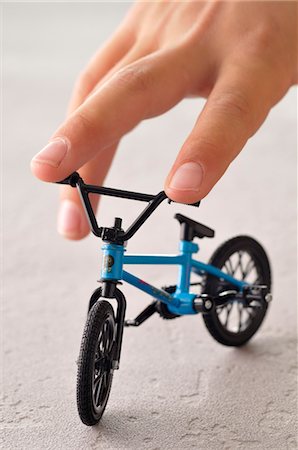 Boy's Hand with Toy Bicycle Stock Photo - Rights-Managed, Code: 700-03601440