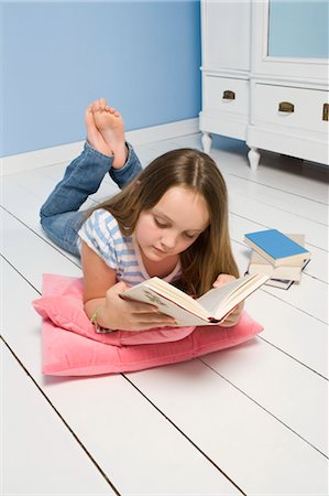 floor cushion - Girl Lying on Floor Reading Book Stock Photo - Rights-Managed, Code: 700-03615824