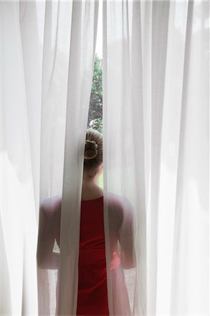 red curtain lady - Rear View of Woman Looking out Window Stock Photo - Rights-Managed, Code: 700-03622701