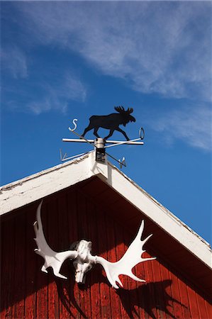 rooftop hut - Weather Vane and Moose Antlers on Red Wooden Garage Stock Photo - Rights-Managed, Code: 700-03622714