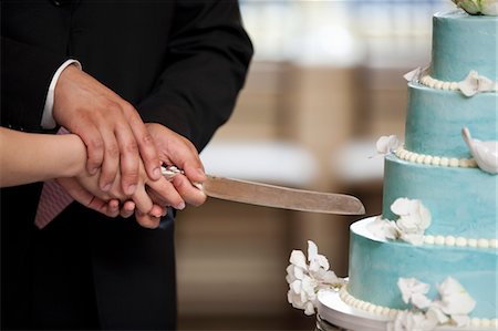 romantic couple holding hands - Bride and Groom Cutting Wedding Cake Stock Photo - Rights-Managed, Code: 700-03644889