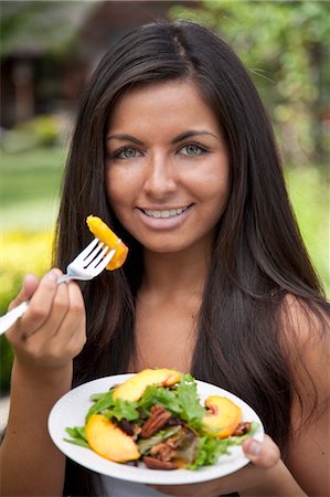 25 yr Old Hispanic Woman eating Organic Lettuce Peaches and Pecans Stock Photo - Rights-Managed, Code: 700-03644966