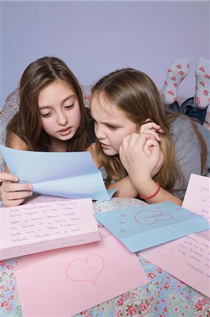 females only bed lying - Two Girls Reading Love Letters on Bed Stock Photo - Rights-Managed, Code: 700-03662322