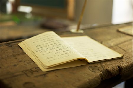 desktop (top surface) - Exercise Book Open on Desk in Museum Classroom, Stroppo, Valle Maira, Italy Stock Photo - Rights-Managed, Code: 700-03681940