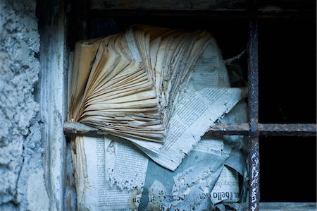 Old Newspaper used as Insulation on Paneless Window in Abandoned Barn Stock Photo - Rights-Managed, Code: 700-03681943