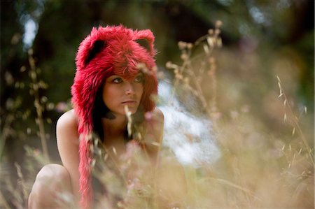 simsearch:700-03682210,k - Woman Wearing Furry Hat Crouched in Long Grass Stock Photo - Rights-Managed, Code: 700-03682210