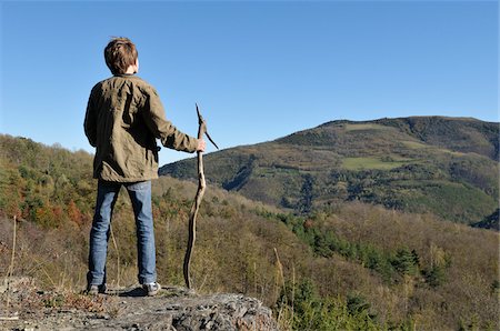 rear view male boy - Boy with Walking Stick Observing Landscape Stock Photo - Rights-Managed, Code: 700-03698236