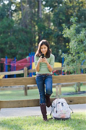 Girl with Cell Phone at Park Stock Photo - Rights-Managed, Code: 700-03719306