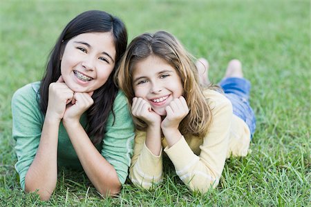 Sisters Lying on Grass Together Stock Photo - Rights-Managed, Code: 700-03719315