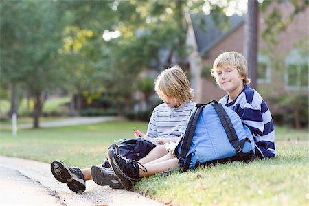 simsearch:632-05844982,k - Boys Sitting on Grass with Backpacks Stock Photo - Rights-Managed, Code: 700-03719318