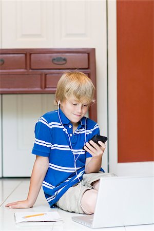 simsearch:700-05803516,k - Boy wearing Earphones with Cell Phone Stock Photo - Rights-Managed, Code: 700-03719325