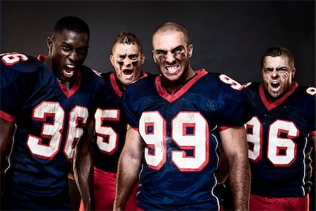 snarling - Quatre joueurs de Football en Studio Photographie de stock - Rights-Managed, Code: 700-03738354