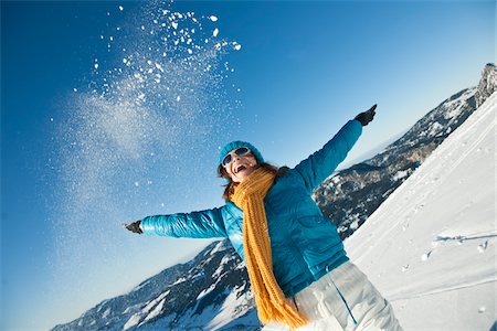 single mature woman and snow - Woman Tossing Snow with Outstretched Arms Stock Photo - Rights-Managed, Code: 700-03739228