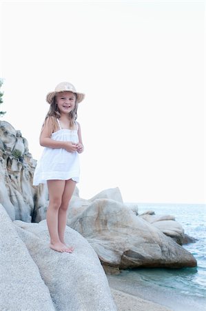 Girl Standing on Boulder at Beach Stock Photo - Rights-Managed, Code: 700-03739279