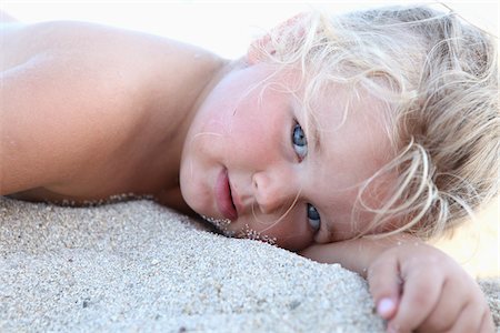 eyes and nose - Little Girl Lying on Sand Stock Photo - Rights-Managed, Code: 700-03739335