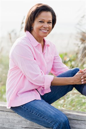 Portrait of Woman Sitting on Railing Stock Photo - Rights-Managed, Code: 700-03762652