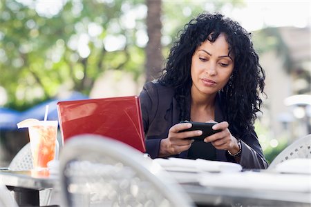 Businesswoman with Cell Phone and Laptop on Patio Foto de stock - Con derechos protegidos, Código: 700-03762699