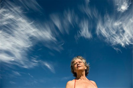 simsearch:700-03762782,k - Low View of Woman Against Blue Sky Stock Photo - Rights-Managed, Code: 700-03762784