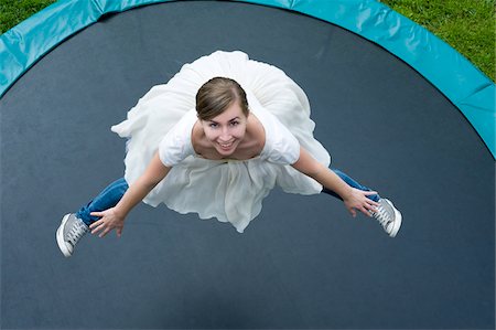 Teenage Girl Wearing Ballerina Dress and Jeans Jumping on Trampoline Foto de stock - Con derechos protegidos, Código: 700-03777743