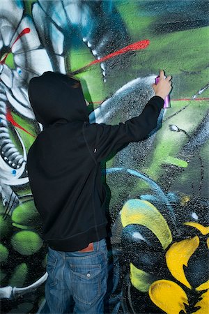 rebell - Boy Spray Painting Graffiti Stock Photo - Rights-Managed, Code: 700-03787574