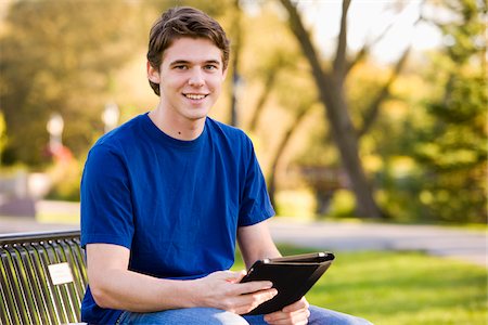 enjoy ipad - Man Sitting on Park Bench Holding iPad Stock Photo - Rights-Managed, Code: 700-03799534