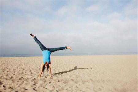 Woman Doing Cartwheel on Beach Stock Photo - Rights-Managed, Code: 700-03814382