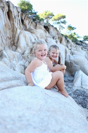 simsearch:600-07434963,k - Sisters Sitting on Rocks Stock Photo - Rights-Managed, Code: 700-03814459