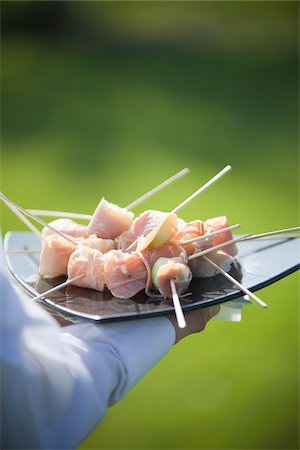 Prosciutto Wrapped Melon Skewers Being Served on Tray Stock Photo - Rights-Managed, Code: 700-03814745