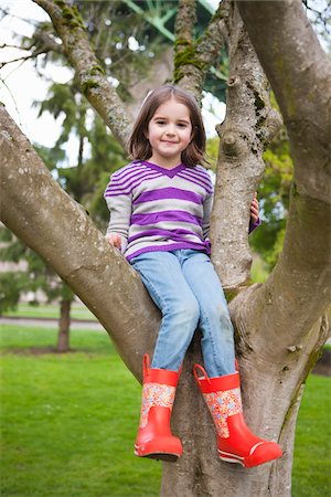 rain boots for girls - Girl Sitting in Tree Stock Photo - Rights-Managed, Code: 700-03814996