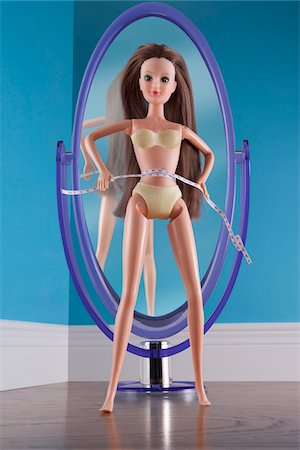 success conceptual - Doll Measuring Waist in front of Mirror Stock Photo - Rights-Managed, Code: 700-03815231