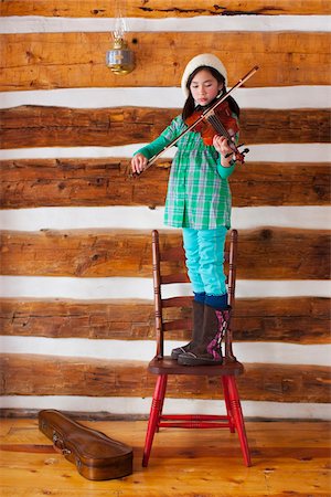 Girl Standing on Chair and Playing Violin Stock Photo - Rights-Managed, Code: 700-03849316
