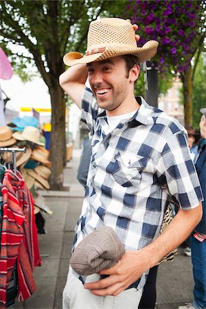shopping outdoors usa model release - Man Trying on Hat at Market Stock Photo - Rights-Managed, Code: 700-03865236