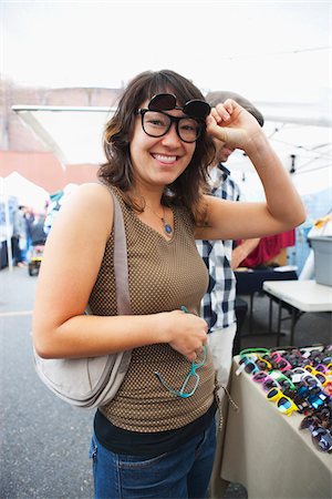 eye wear - Woman Trying on Sunglasses at Market Kiosk Stock Photo - Rights-Managed, Code: 700-03865239