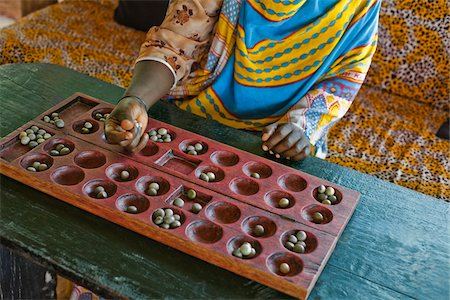 Woman Playing Bao, Zanzibar, Tanzania, Africa Fotografie stock - Rights-Managed, Codice: 700-03865395