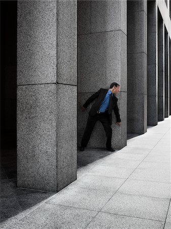 fear scared hiding - Businessman Peeking Around Column Stock Photo - Rights-Managed, Code: 700-03891182