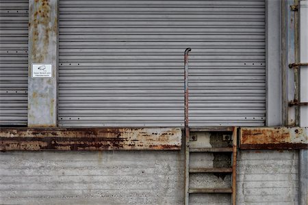 delivery door - outdoors, Hamburg, Germany, PR No, rollup door, rolling door, entrance, door, open, old, ladder, security, scary, grey, rust, video-observance, supply, delivery, back door, rear entrance, receipt of goods, receiving area Stock Photo - Rights-Managed, Code: 700-03958147