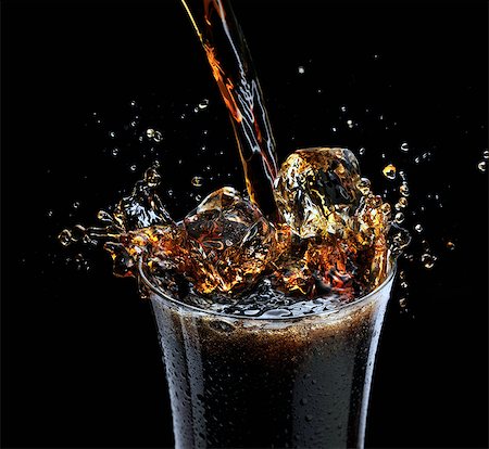 Coca Cola splashing into a glass with ice Stock Photo - Rights-Managed, Code: 824-07562795